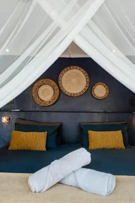 a room with two plates and towels on a bed at Geelslang Paradise - Kruger Park in Marloth Park