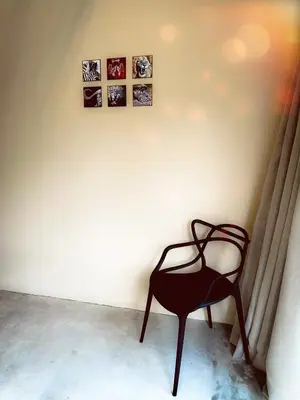 a chair in a room with pictures on the wall at Geelslang Paradise - Kruger Park in Marloth Park