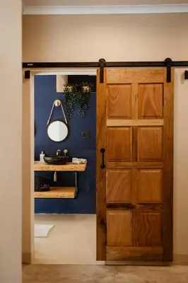 a door leading into a room with a blue wall at Geelslang Paradise - Kruger Park in Marloth Park
