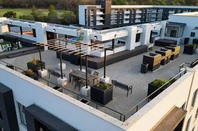 an aerial view of a building with tables and benches at Apartments at Brooklyn/Waterkloof in Pretoria
