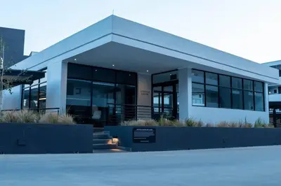 a building with a sign in front of it at Apartments at Brooklyn/Waterkloof in Pretoria