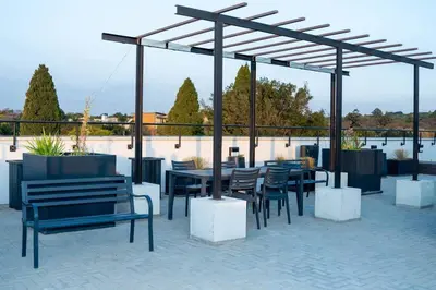 a patio with tables and chairs under a pavilion at Apartments at Brooklyn/Waterkloof in Pretoria