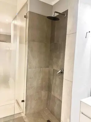 a shower with a glass door in a bathroom at Apartments at Brooklyn/Waterkloof in Pretoria