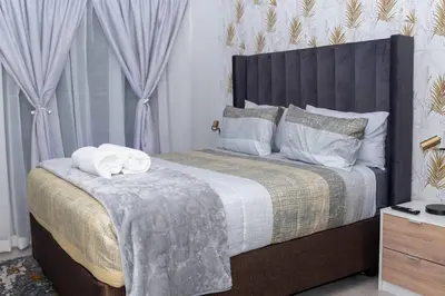a bedroom with a bed with two towels on it at Apartments at Brooklyn/Waterkloof in Pretoria
