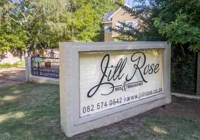 a sign for a will rise house in a yard at The Rose Cottage B&B in Dullstroom