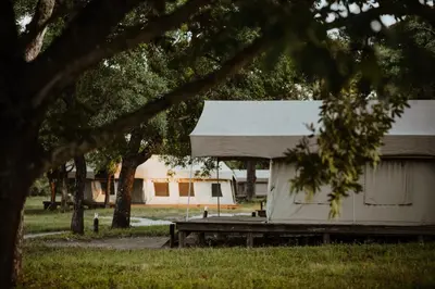 a white building with a tent in a park at Unyati Safari Lodge in Hectorspruit