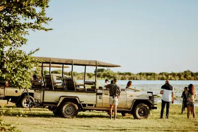 a group of people standing around a jeep at Unyati Safari Lodge in Hectorspruit