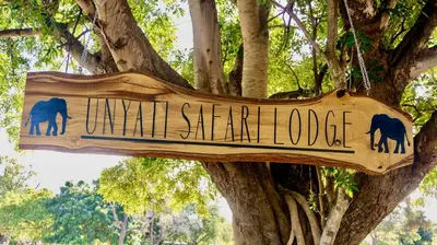 a sign that reads twill spear lodge in front of a tree at Unyati Safari Lodge in Hectorspruit