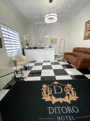 a living room with a black and white checkered floor at Ditoro Boutique Hotel in Pretoria