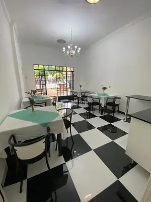 a dining room with tables and chairs on a checkered floor at Ditoro Boutique Hotel in Pretoria