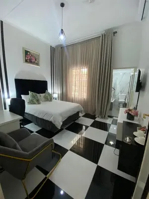 a bedroom with a black and white checkered floor at Ditoro Boutique Hotel in Pretoria