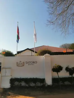 a building with two flags on top of it at Ditoro Boutique Hotel in Pretoria
