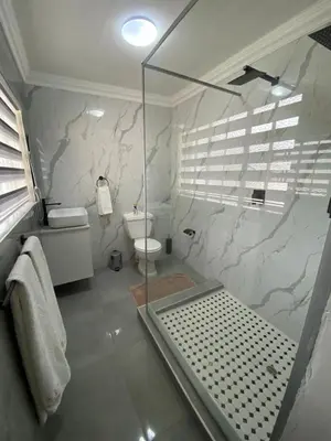 a bathroom with a glass shower and a toilet at Ditoro Boutique Hotel in Pretoria