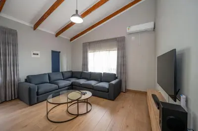 a living room with a couch and a table at Utopia on the Rock1 in Nelspruit