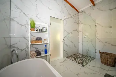 a bathroom with a shower and a toilet and a sink at Utopia on the Rock1 in Nelspruit
