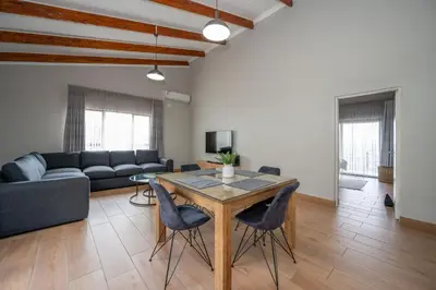 a living room with a table and a couch at Utopia on the Rock1 in Nelspruit