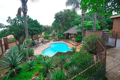 a backyard with a swimming pool and a gazebo at Menlyn Maine - The Smart Home in Pretoria