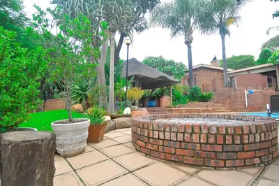 a patio with a brick fountain in a yard at Menlyn Maine - The Smart Home in Pretoria