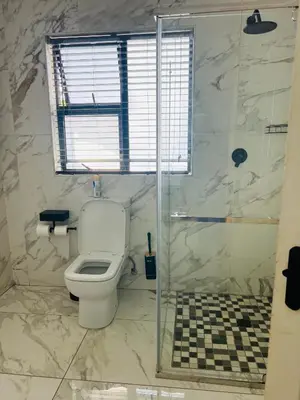 a bathroom with a toilet and a shower at Maison De luxe in Thohoyandou