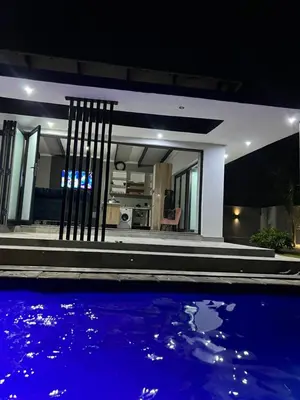 a house with a swimming pool at night at Maison De luxe in Thohoyandou