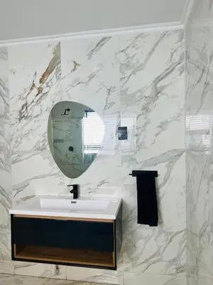 a bathroom with a sink and a mirror at Maison De luxe in Thohoyandou
