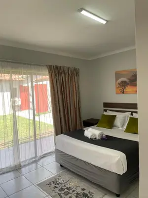 a bedroom with a bed and a large window at 473 On Cliff in Pretoria