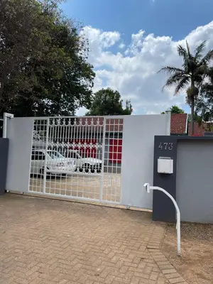 a white fence with a gate with a car on it at 473 On Cliff in Pretoria