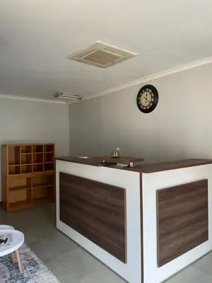 a room with a counter with a clock on the wall at 473 On Cliff in Pretoria