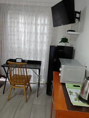 a kitchen with a table and a desk with a computer at The Affectionate One in Louis Trichardt