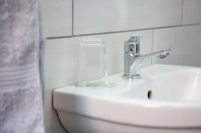 a bathroom sink with a toothbrush holder on top of it at The Affectionate One in Louis Trichardt