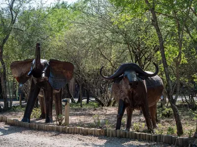 a statue of two bulls standing next to trees at Kruger Maroela Lodge in Marloth Park