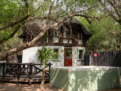 a house with a fence in front of it at Kruger Maroela Lodge in Marloth Park