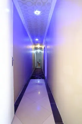 a hallway with a blue corridor with a hallway at Home Life Guesthouse in Midrand