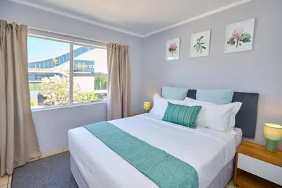 a bedroom with a large bed and a window at Unit 309 at Menlyn Place in Pretoria