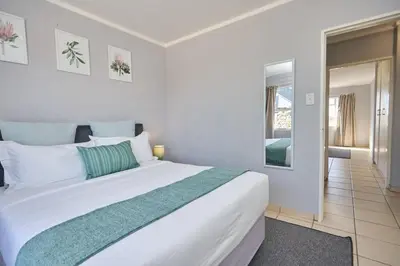 a bedroom with a large white bed in a room at Unit 309 at Menlyn Place in Pretoria