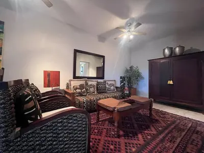 a living room with a couch and a table at Lake house retreat in Haenertsburg