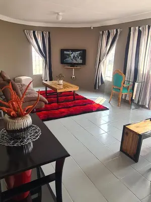 a living room with a couch and a table at 46 Charles Bed and Breakfast in Tierpoort