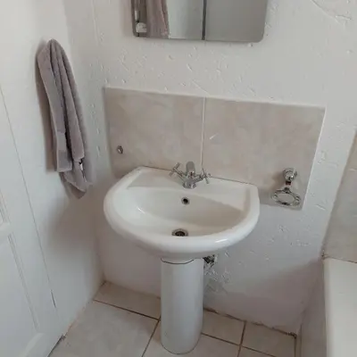 a bathroom with a sink and a toilet at 46 Charles Bed and Breakfast in Tierpoort