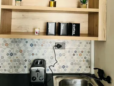 a kitchen with a sink and a counter with aounter at Tshepang Apartments Secunda in Secunda