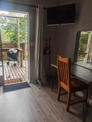 a room with a desk and a chair and a window at White River Stay in White River