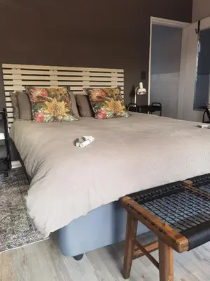 a bed with a cat laying on top of it at White River Stay in White River