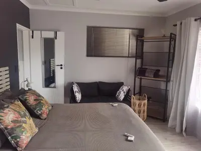 a living room with a bed and a couch at White River Stay in White River