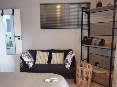 a living room with a couch and a window at White River Stay in White River