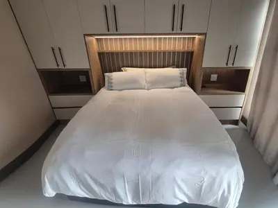 a large white bed in a room with white cabinets at 2 Lanner holiday home in Hartbeespoort