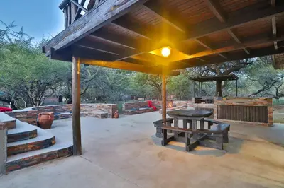 a pavilion with a picnic table and a bench at P.A.P.E's RETREAT in Marloth Park