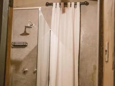 a shower curtain is hanging in a bathroom at Minara Private Boutique Game Lodge in Dinokeng Game Reserve