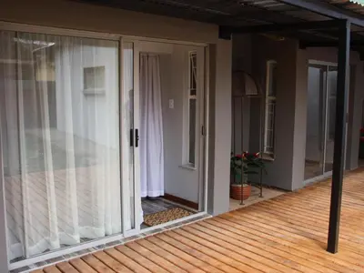a screened porch with sliding glass doors on a house at Blesbok Inn in Polokwane