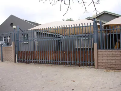 a metal fence in front of a building at Blesbok Inn in Polokwane