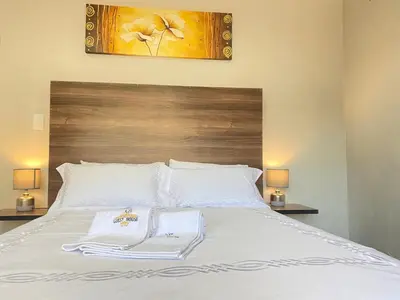 a bed with two white towels on top of it at KB Guesthouse in Groblersdal