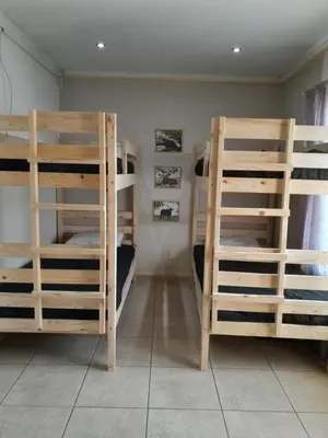 a room with three bunk beds in a room at Secunda BackPackers in Secunda